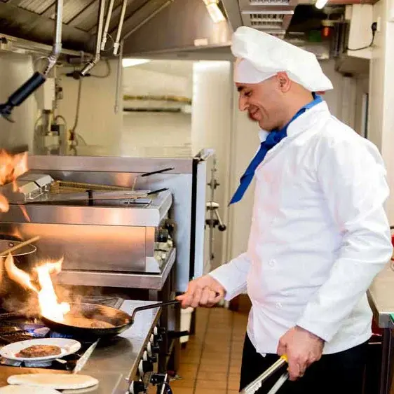 The Peaks at Santa Rita Chef Created Meals, chef frying a dish.